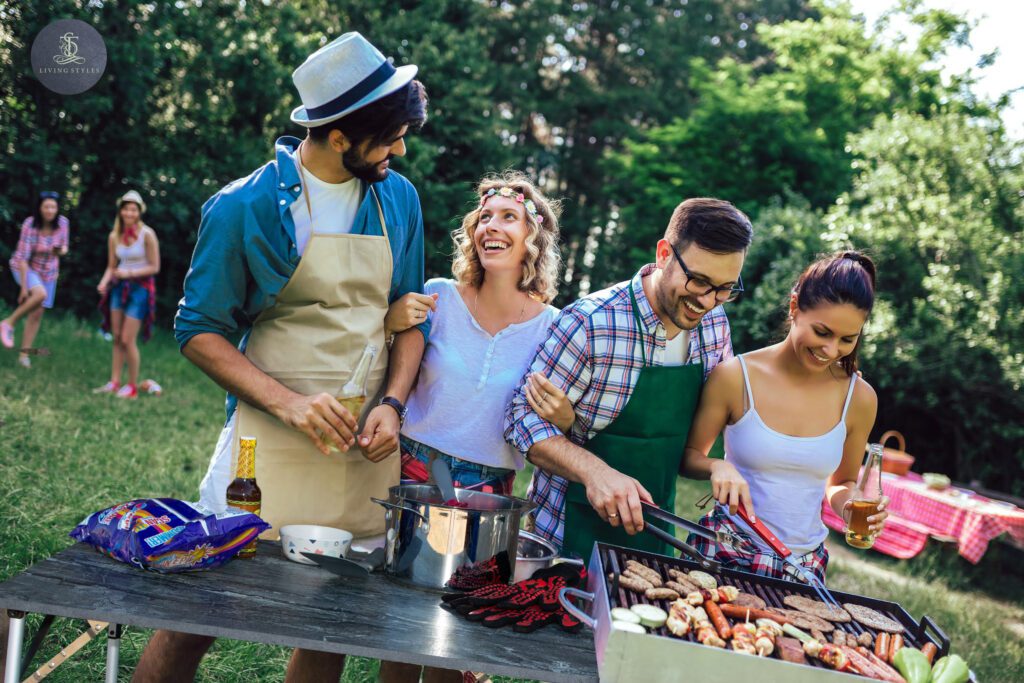 A group of people standing around a grill.