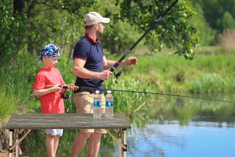 A man and boy fishing on the water.