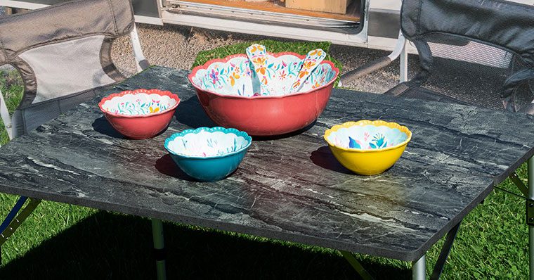 A table with bowls and spoons on it