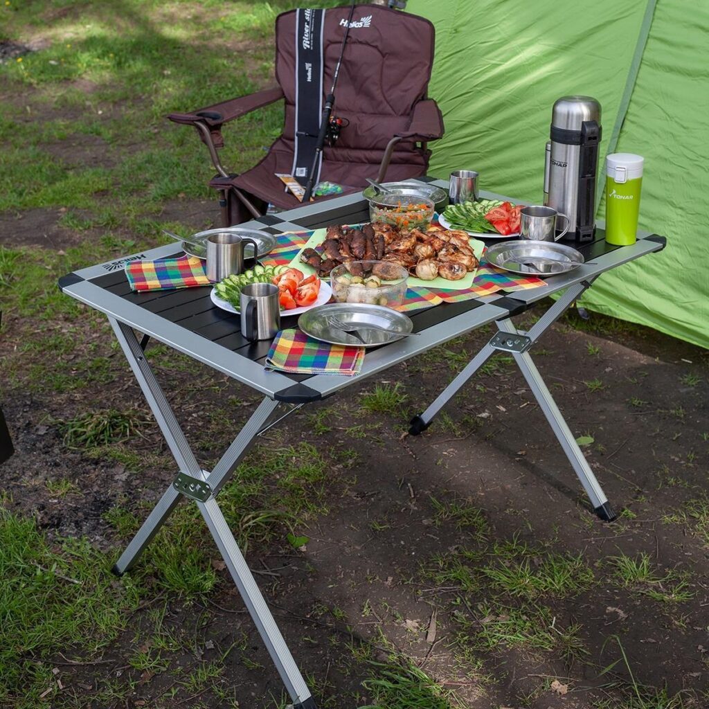 A table with food on it in the grass.