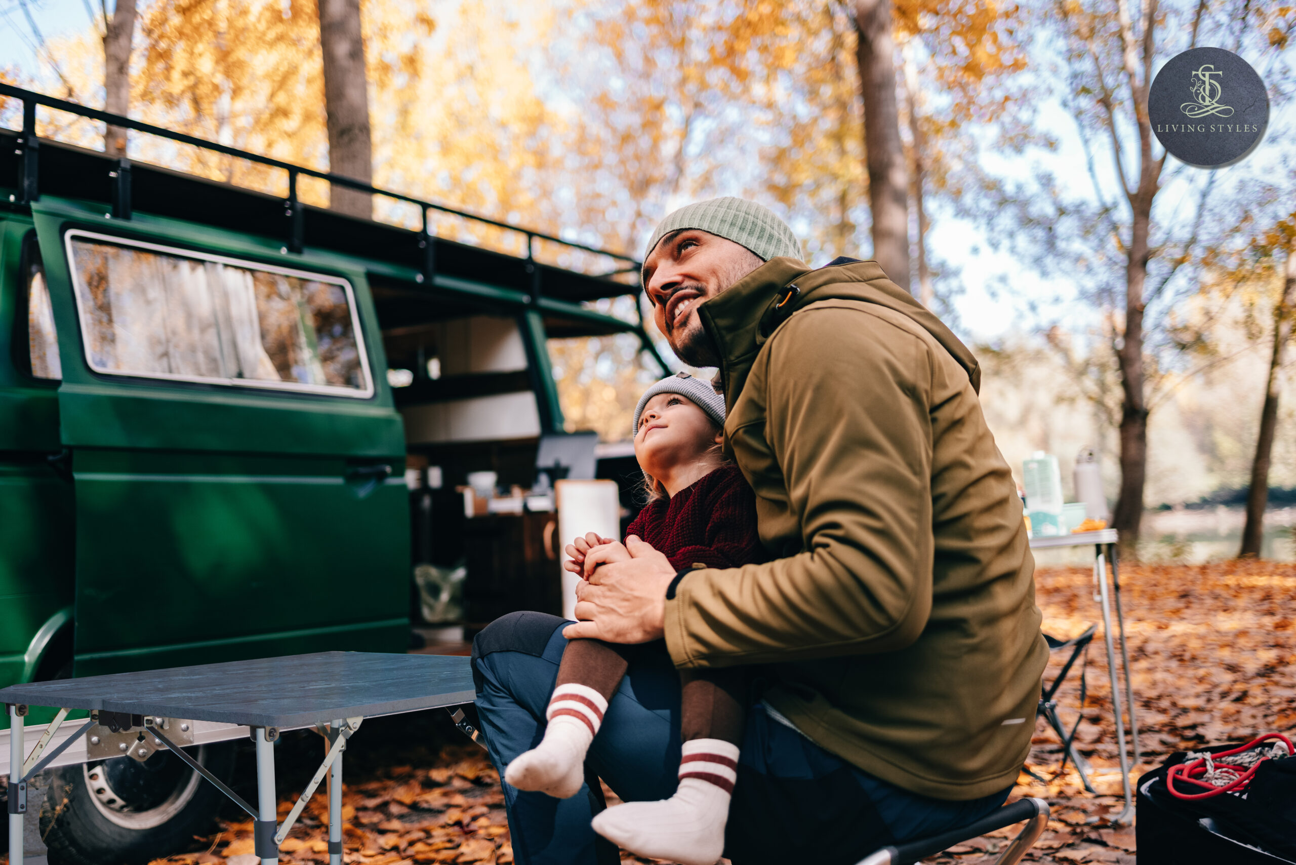 A man and child sitting in front of an open truck.