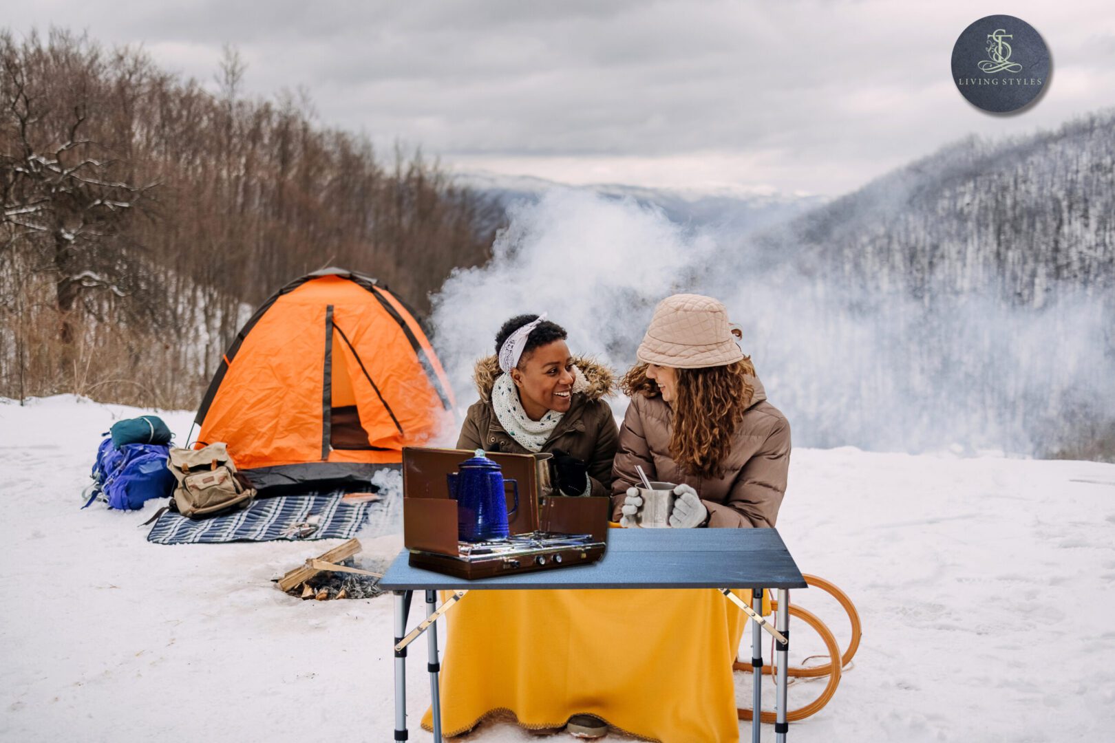 Two women sitting at a table outside in the snow.